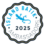 Island Batik Ambassador 2025 scalloped circle emblem badge featuring blue lizard logo